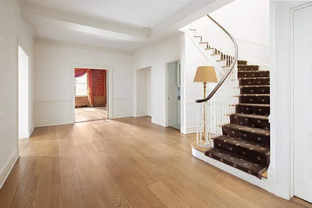 a view of an entryway with wooden floor and staircase