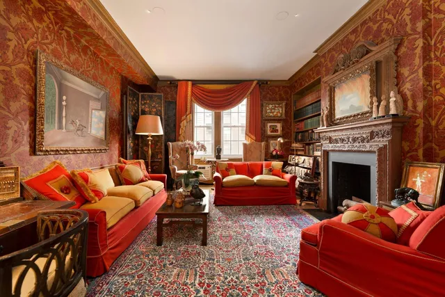 a living room with furniture a fireplace and a large window