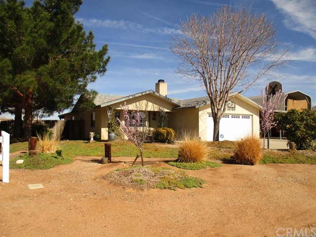 22760 Motnocab Road Apple Valley, CA 92307 - Photo 1 of 1 a view of a yard with a tree