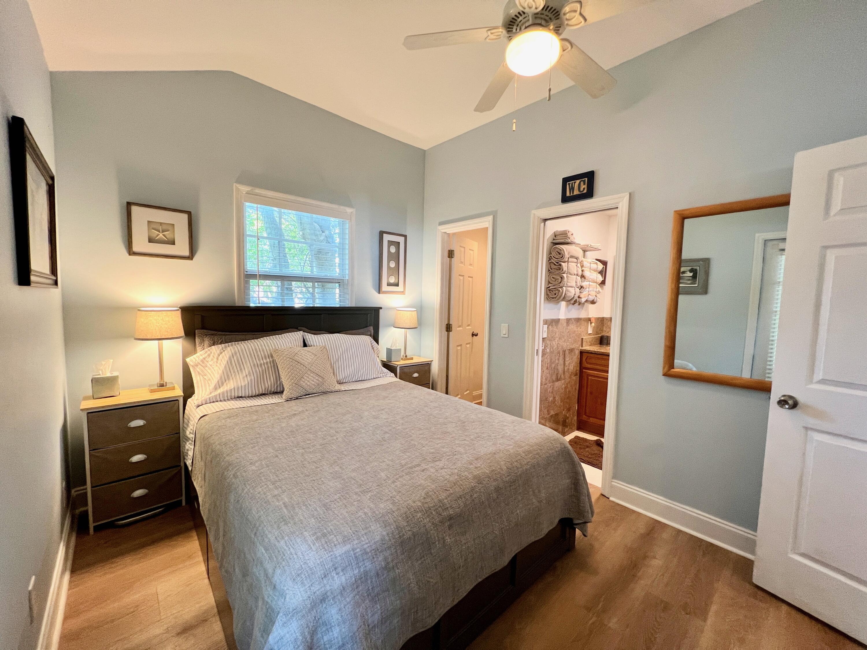 904 Terry Lane, Unit 4 Key West, FL 33040 - Photo 5 of 14 a bedroom with a bed and a chandelier