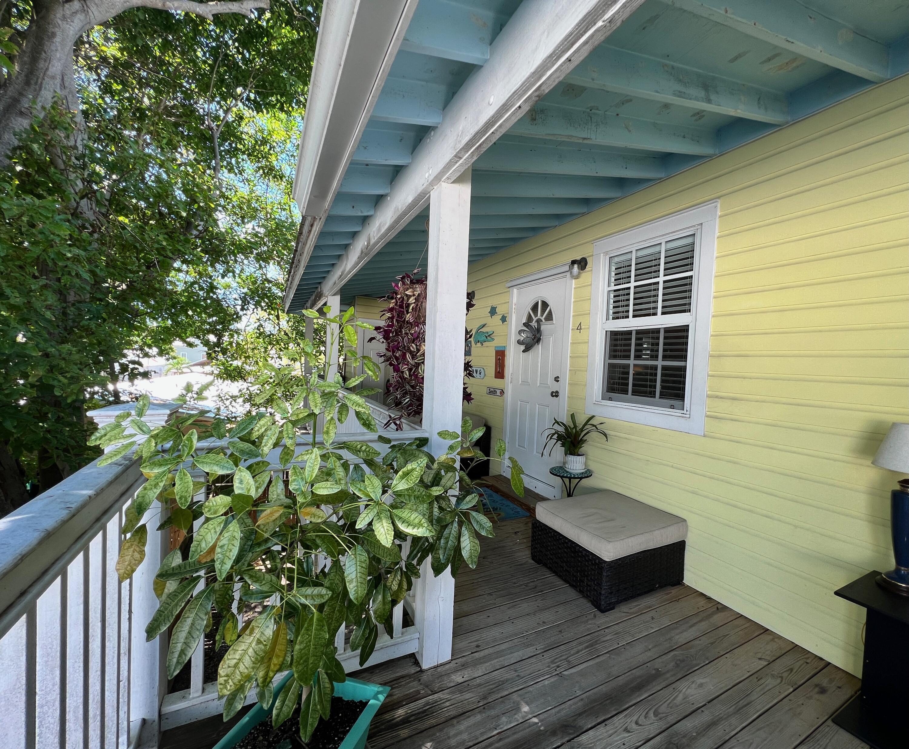904 Terry Lane, Unit 4 Key West, FL 33040 - Photo 10 of 14 a house with potted plants in front of it