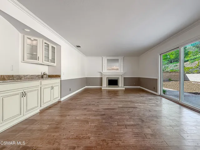 a large kitchen with cabinets and stainless steel appliances