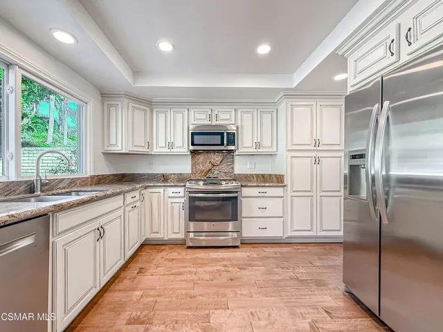 a kitchen with a sink and large window