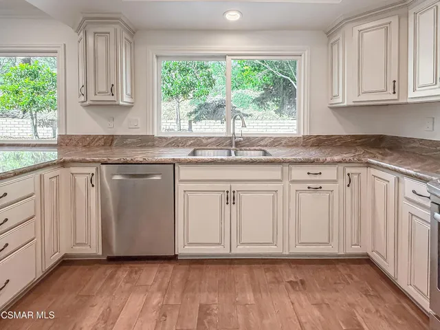 a stove top oven sitting inside of a kitchen