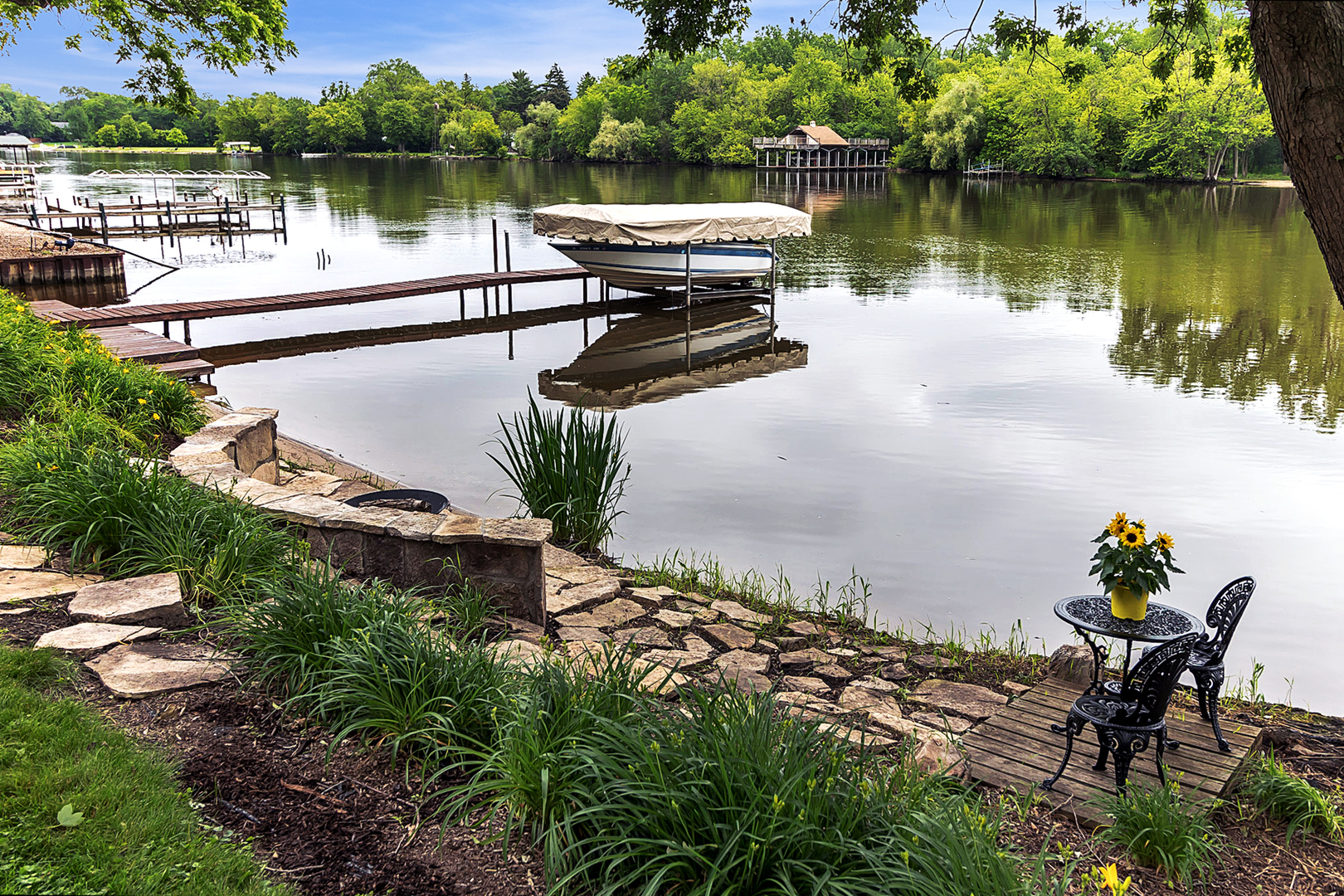 209 Mildred Avenue Cary, IL 60013 - Photo 29 of 29 a view of a lake with a bench next to a yard