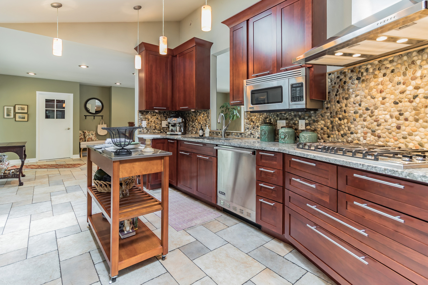 209 Mildred Avenue Cary, IL 60013 - Photo 4 of 29 a kitchen with stainless steel appliances granite countertop wooden cabinets a stove top oven a sink and dishwasher