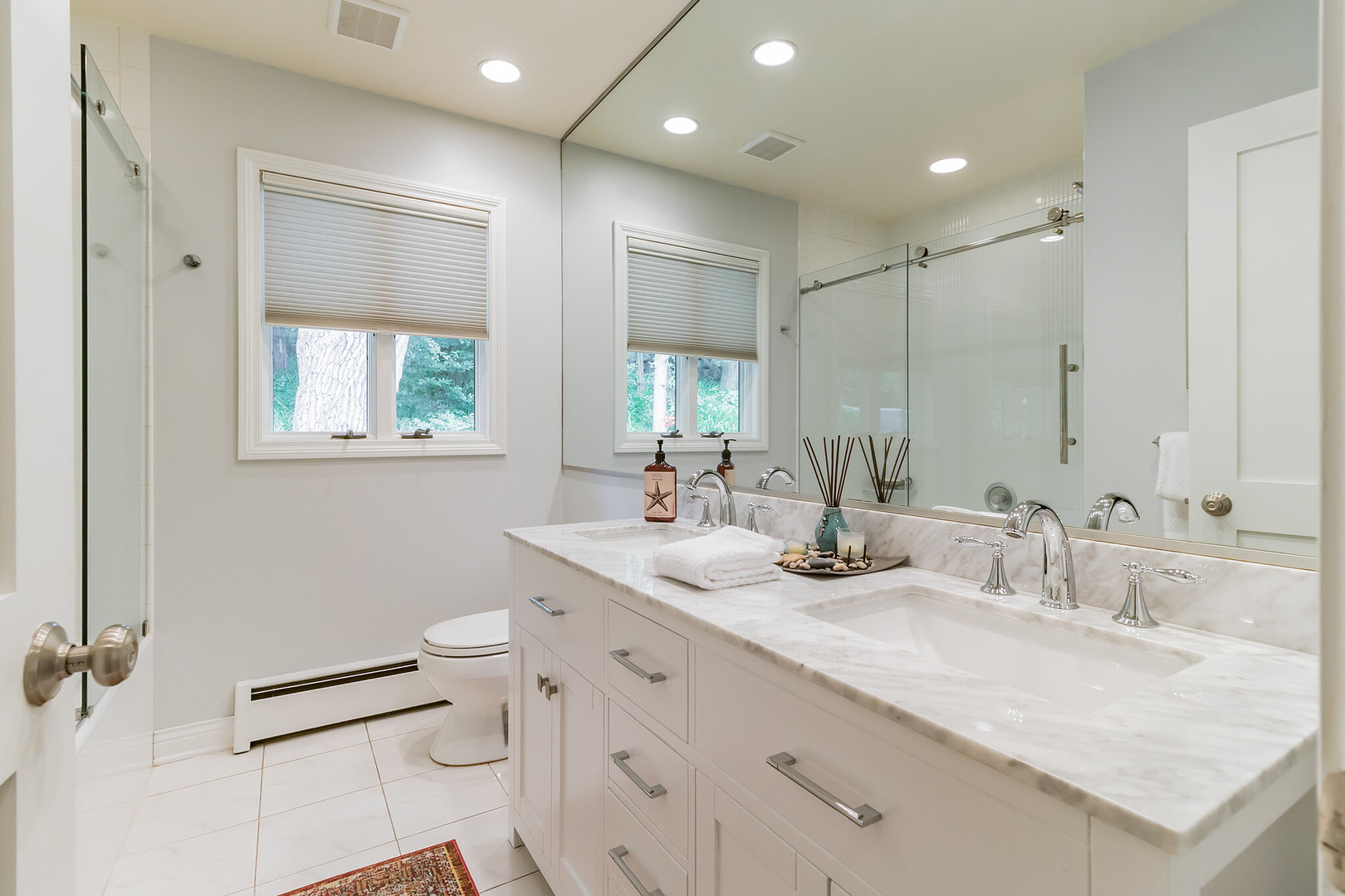 209 Mildred Avenue Cary, IL 60013 - Photo 9 of 29 a bathroom with a double vanity sink toilet and mirror