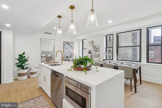 a kitchen with a sink a stove and chairs