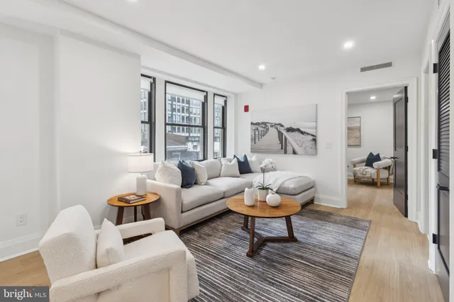 a living room with furniture and a rug
