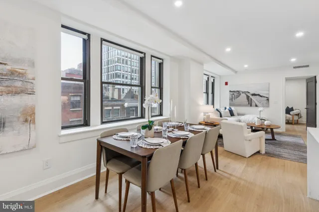 a living room with furniture and large windows