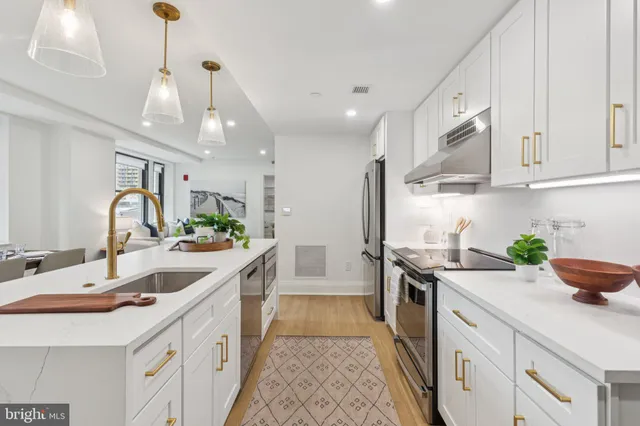 a kitchen with a sink stove and cabinets
