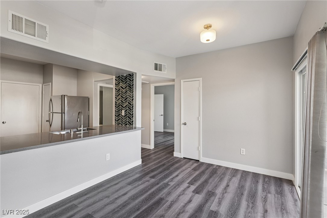 7255 West Sunset Road, Unit 1087 Las Vegas, NV 89113 - Photo 11 of 43 Unfurnished living room featuring dark wood finished floors and baseboards