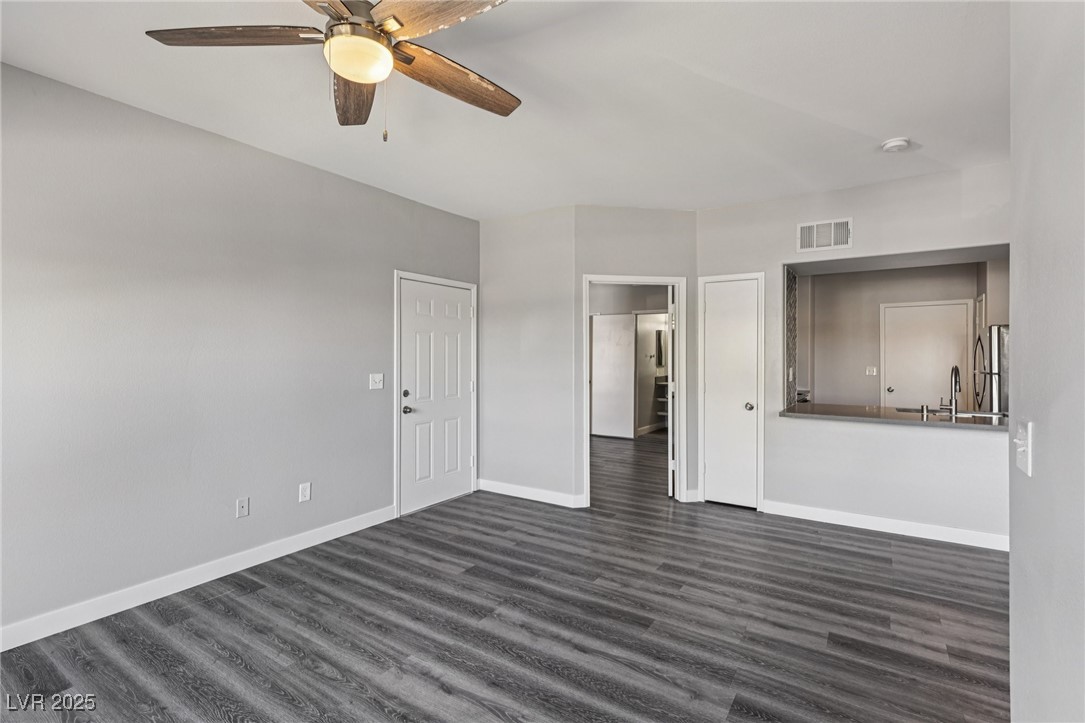 7255 West Sunset Road, Unit 1087 Las Vegas, NV 89113 - Photo 12 of 43 Unfurnished bedroom with dark wood-type flooring, a ceiling fan, and freestanding refrigerator