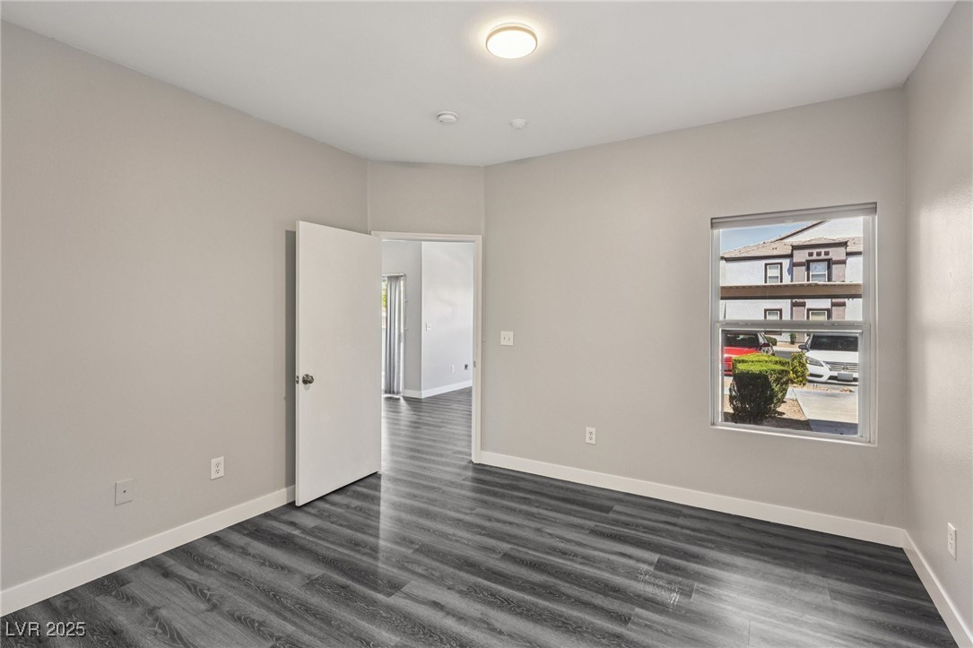 7255 West Sunset Road, Unit 1087 Las Vegas, NV 89113 - Photo 14 of 43 Unfurnished room featuring baseboards and dark wood finished floors