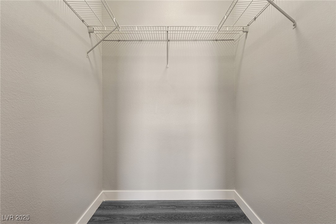 7255 West Sunset Road, Unit 1087 Las Vegas, NV 89113 - Photo 18 of 43 Walk in closet featuring dark wood-style flooring