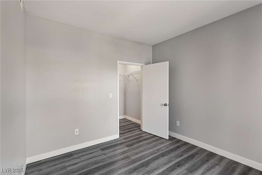 7255 West Sunset Road, Unit 1087 Las Vegas, NV 89113 - Photo 28 of 43 Spare room featuring dark wood-type flooring and baseboards