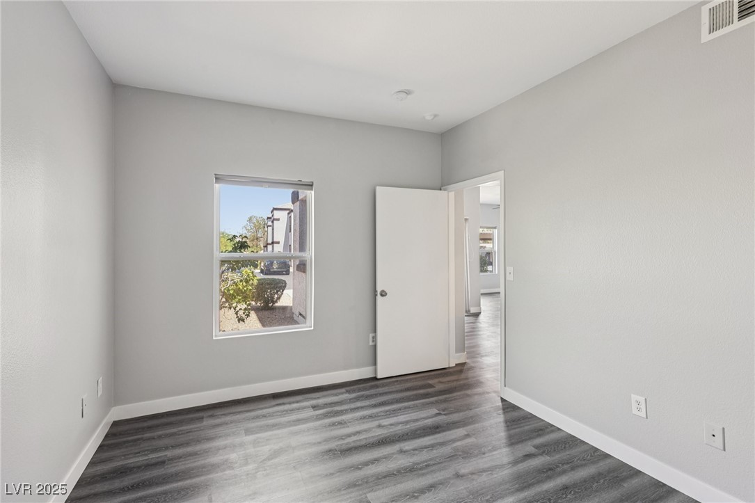 7255 West Sunset Road, Unit 1087 Las Vegas, NV 89113 - Photo 29 of 43 Unfurnished bedroom featuring dark wood-style flooring and baseboards