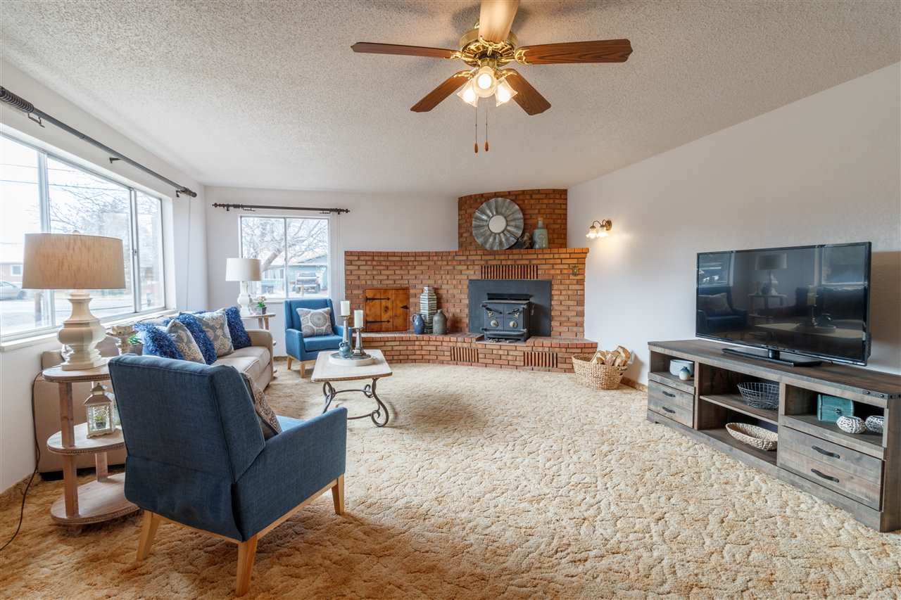 234-28 28 1/2 Road Grand Junction, CO 81503 - Photo 5 of 18 a living room with furniture a flat screen tv and a fireplace