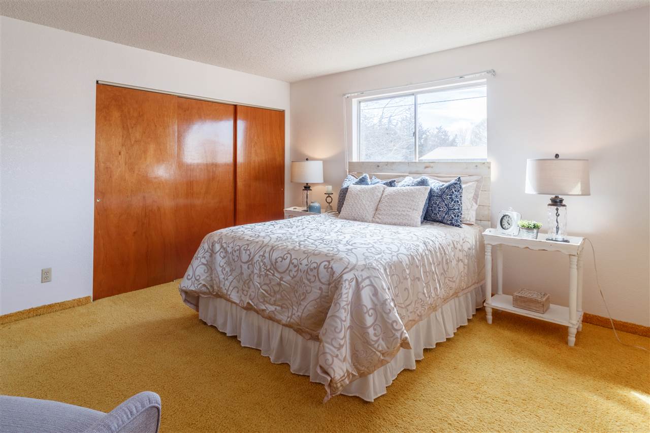 234-28 28 1/2 Road Grand Junction, CO 81503 - Photo 9 of 18 a large bed sitting in a bedroom next to a window