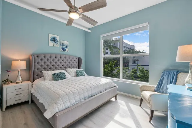 a bedroom with a large bed and a window