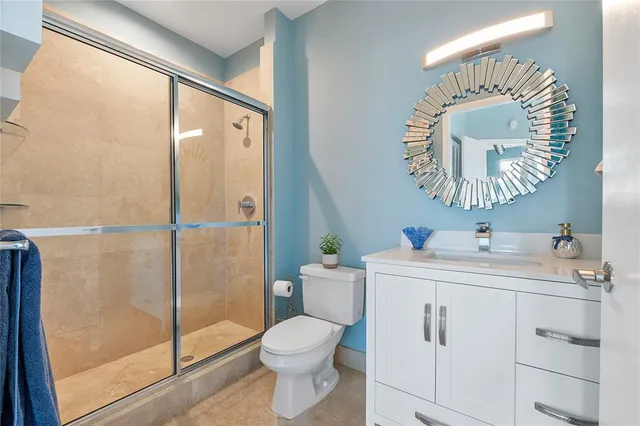 a bathroom with a sink mirror vanity and toilet
