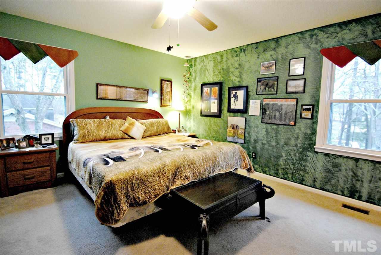 4217 Waterbury Road Raleigh, NC 27604 - Photo 14 of 25 a bed sitting in a bedroom next to a window