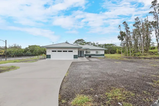 a view of house with outdoor space and parking