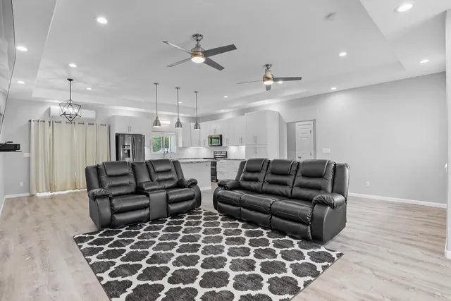 a living room with furniture and a chandelier