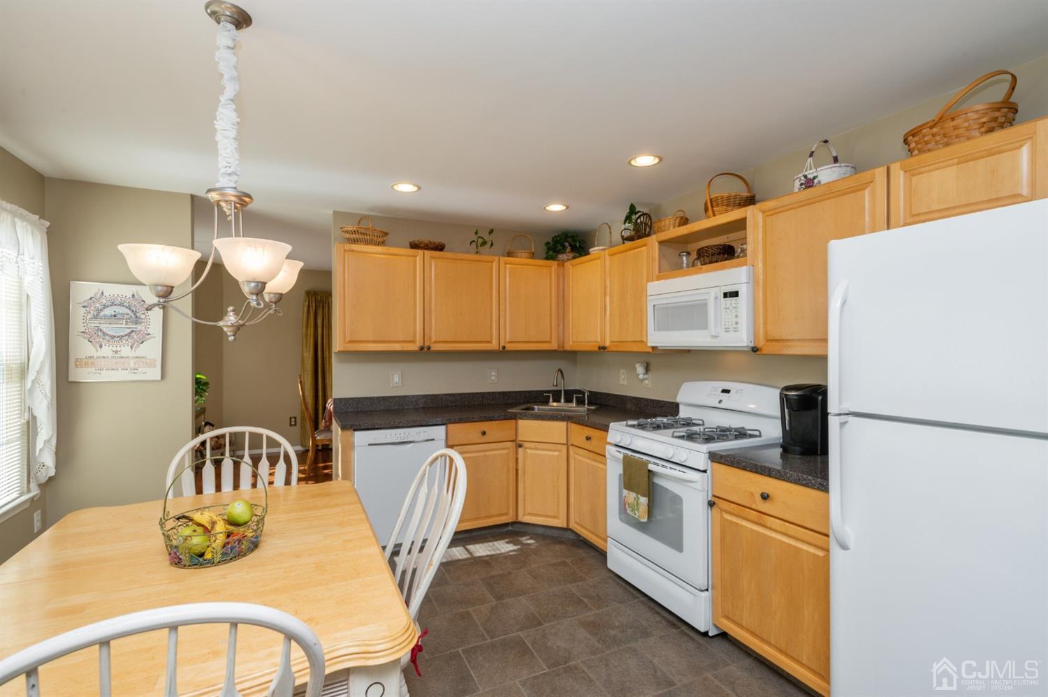 508 Grandview Street Middlesex, NJ 08846 - Photo 4 of 20 a kitchen with stainless steel appliances granite countertop a sink a stove a refrigerator cabinets a dining table and chairs with wooden floor