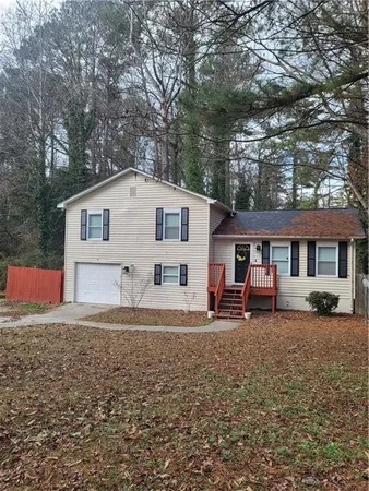 a house that has a tree in front of a house