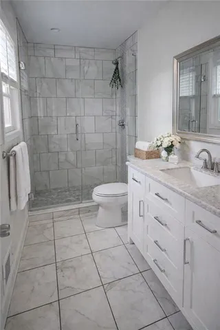 a bathroom with a sink a toilet and shower