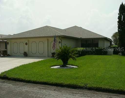 a view of a house with backyard and garden