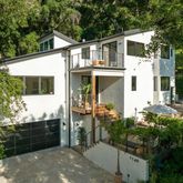 a view of a house with yard and sitting area