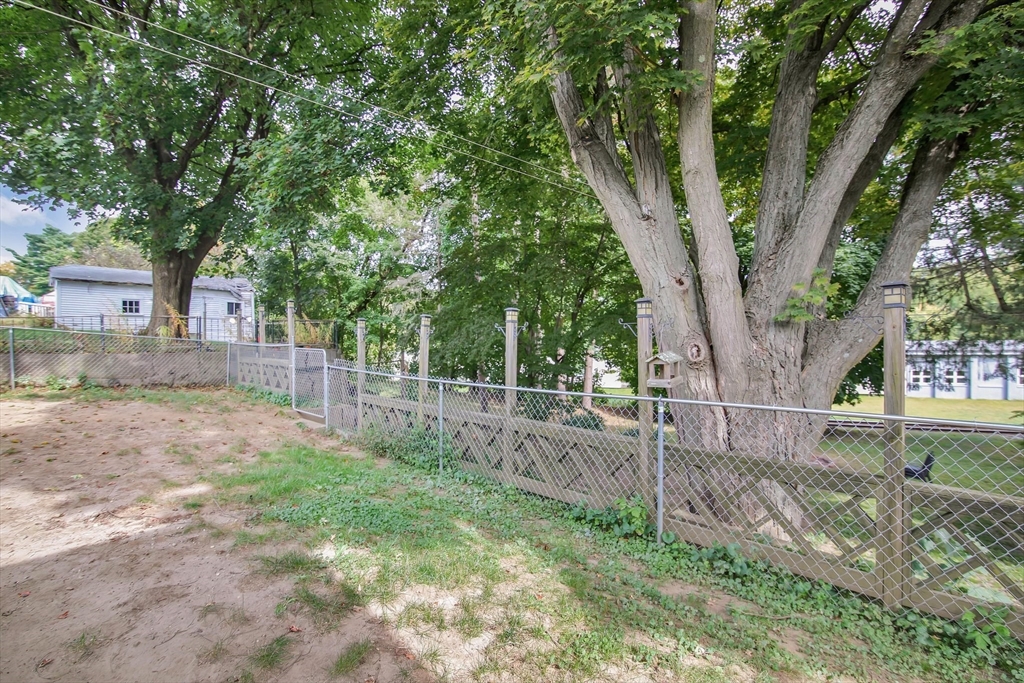 25 North Street Three Rivers, MA 01080 - Photo 33 of 33 a view of a yard with large tree and wooden fence