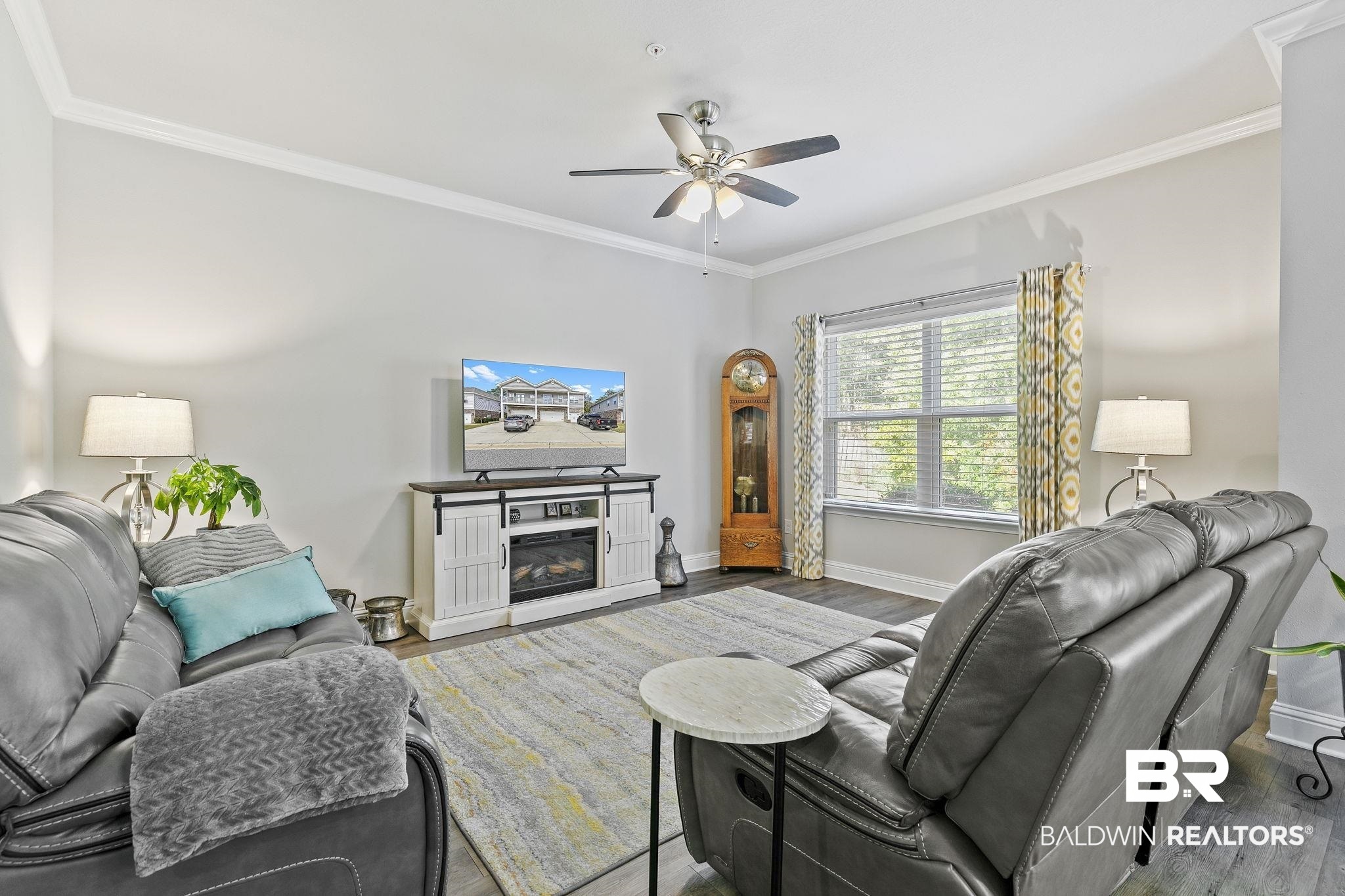6867 Spaniel Drive, Unit B Daphne, AL 36527 - Photo 7 of 36 Living room featuring crown molding, a fireplace, ceiling fan, and hardwood / wood-style flooring
