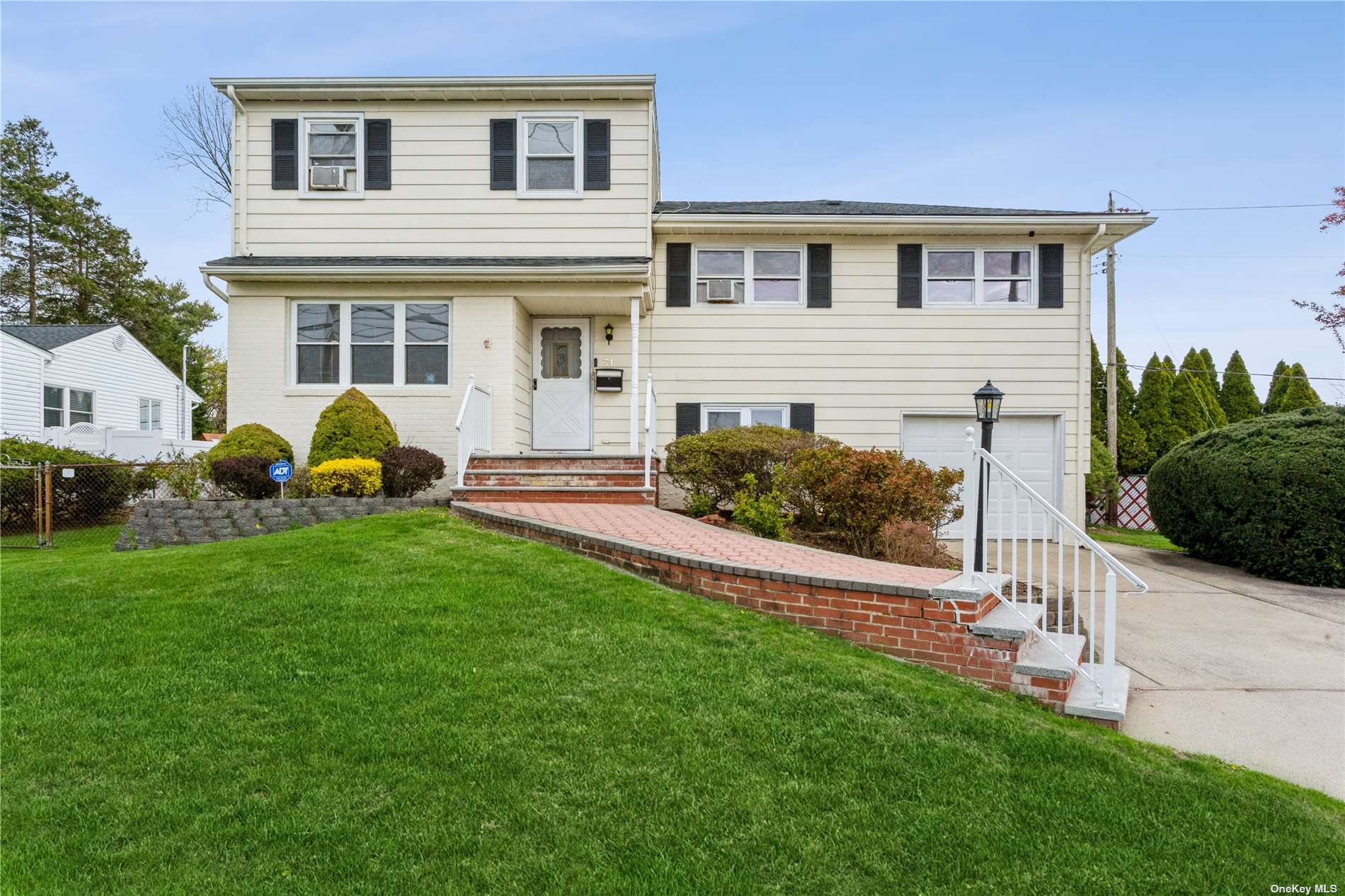 a front view of house with yard and outdoor seating
