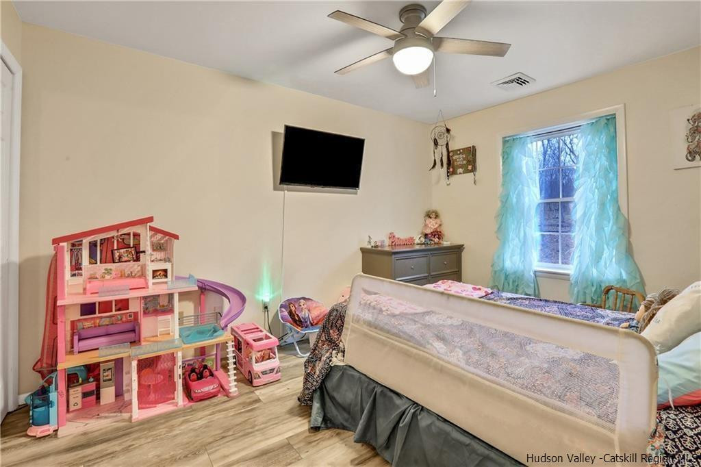 262 Potic Mountain Road Catskill, NY 12414 - Photo 25 of 30 a bedroom with a bed and a flat screen tv