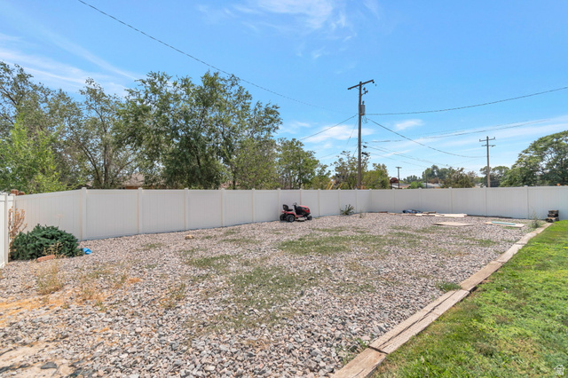 7391 Elm Street Midvale, UT 84047 - Photo 35 of 38 Xlarge rocked RV parking totally fenced with a side gate to park right in.