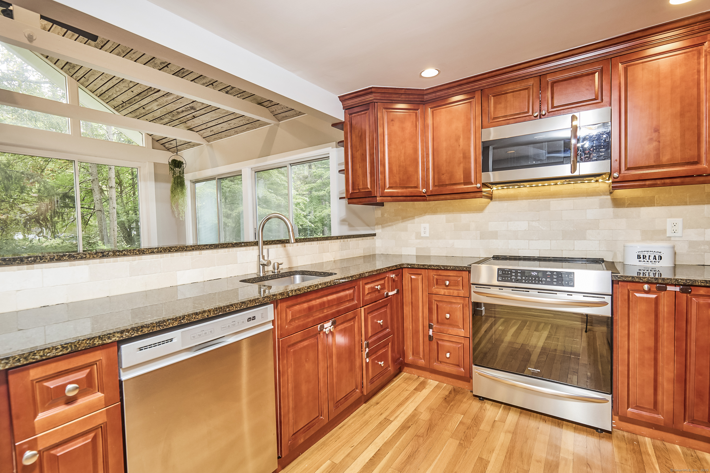 4 Colony Road Weston, CT 06883 - Photo 11 of 39 a kitchen with stainless steel appliances granite countertop a sink stove and cabinets