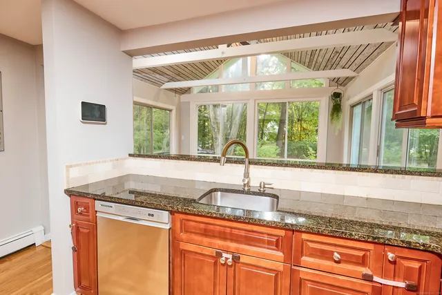 a kitchen with granite countertop a sink and a window