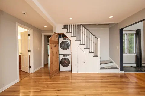 a view of a hallway with a washer and dryer