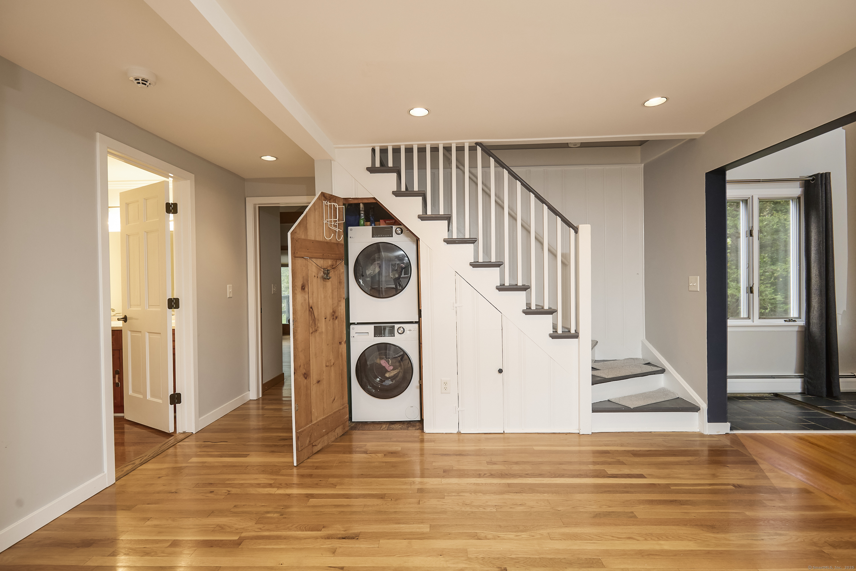 4 Colony Road Weston, CT 06883 - Photo 23 of 39 a view of a hallway with a washer and dryer