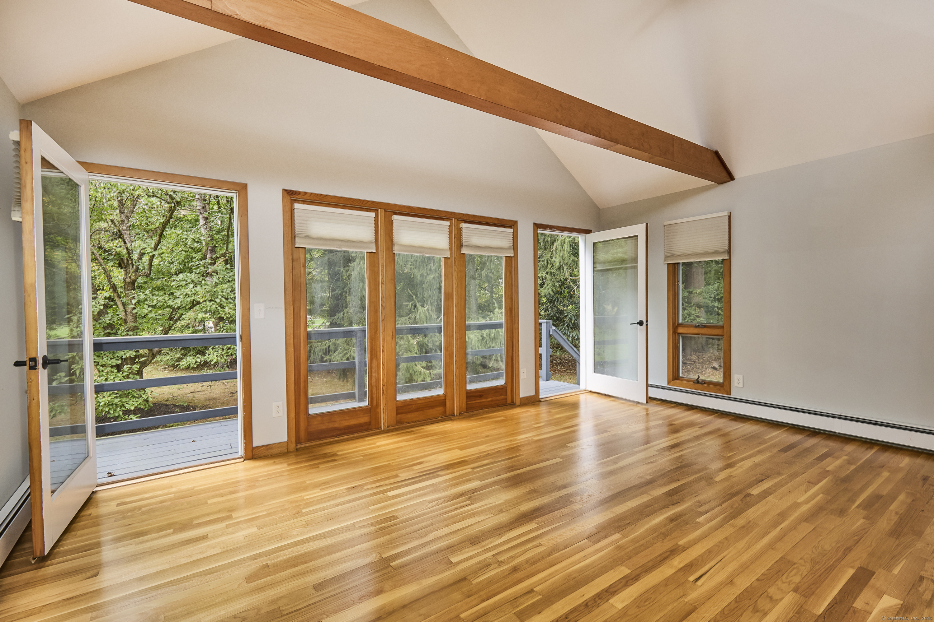 4 Colony Road Weston, CT 06883 - Photo 24 of 39 a view of an empty room with wooden floor and a window