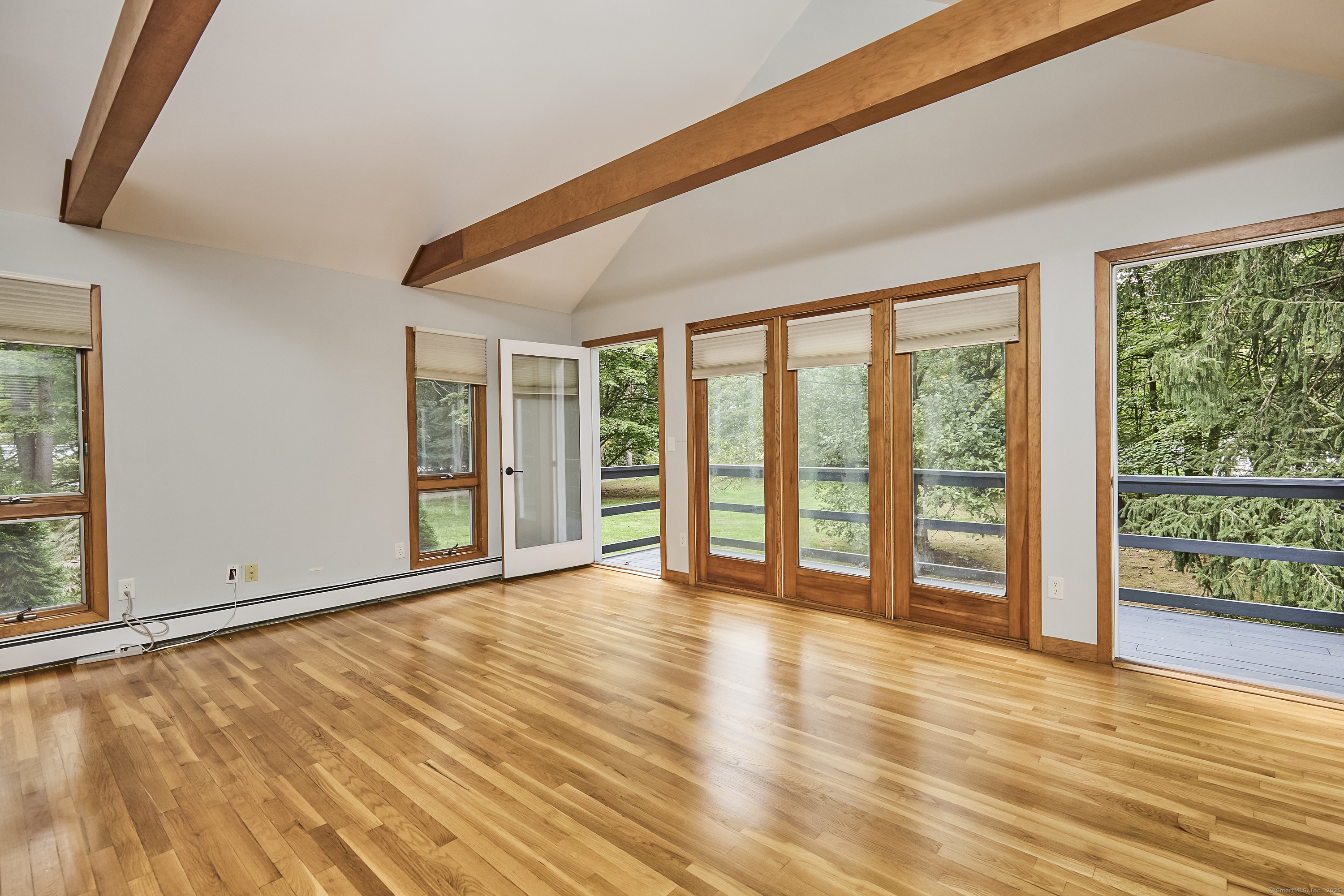 4 Colony Road Weston, CT 06883 - Photo 25 of 39 a view of an empty room with wooden floor and a window