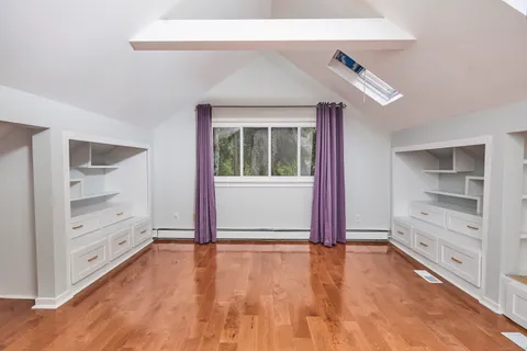 a view of room with window and hardwood floor