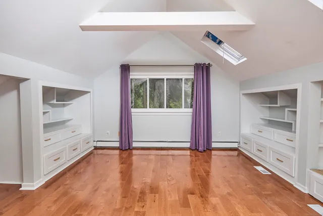 a view of room with window and hardwood floor