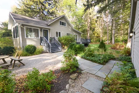 a front view of a house with a garden