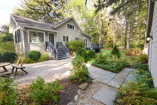 a front view of a house with a garden