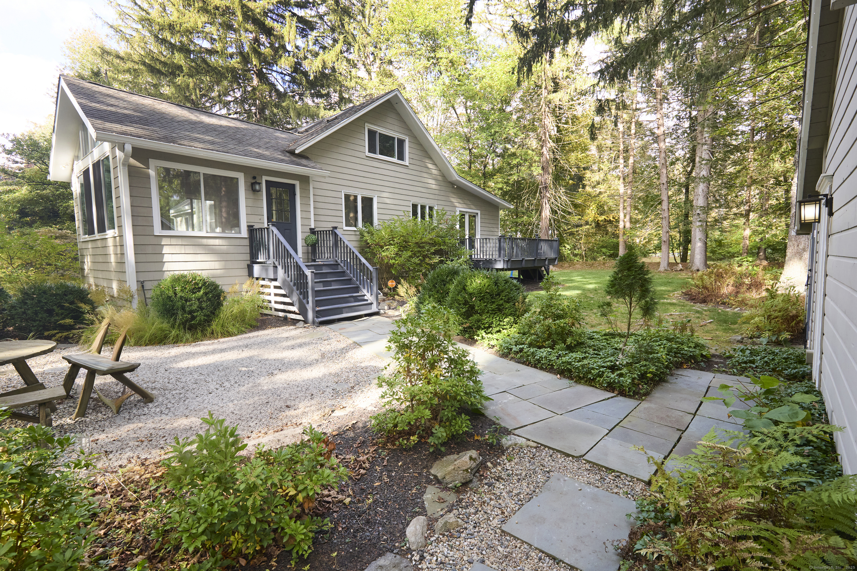 4 Colony Road Weston, CT 06883 - Photo 31 of 39 a front view of a house with a garden