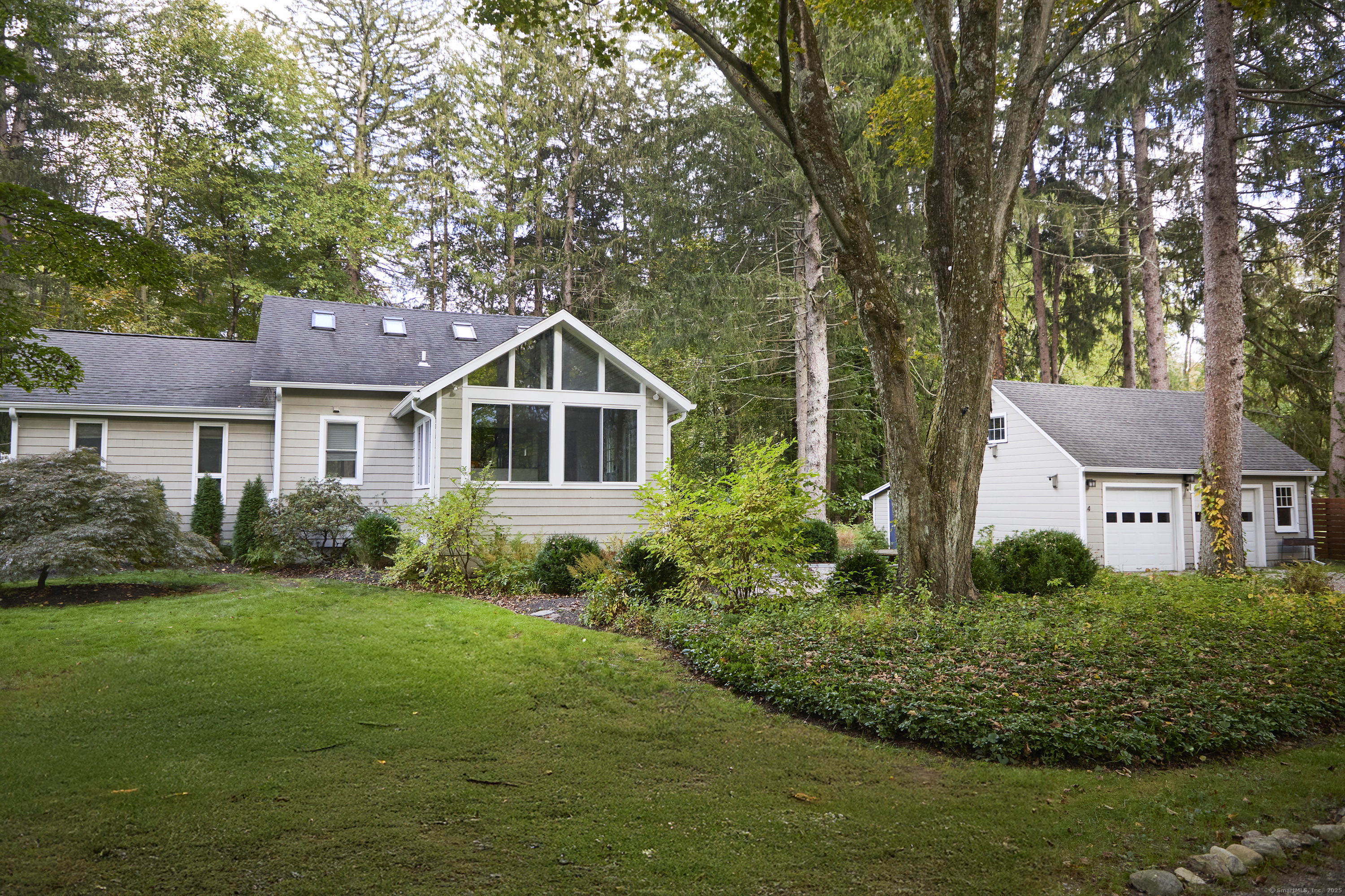 4 Colony Road Weston, CT 06883 - Photo 36 of 39 a front view of a house with a yard